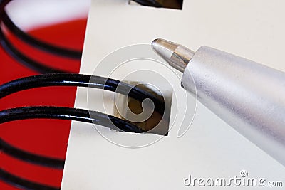 Time to study and business. A silver fountain pen is lying on a sheet of notebook with a spring. Close-up. Macro Stock Photo