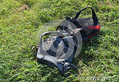Time to take a break and rest. Two packed rucksacks on the grass waiting for the tourists to go hiking Stock Photo