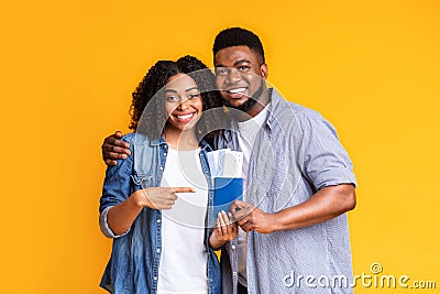 Time To Travel. Happy Black Spouses Ponting At Passports With Flight Tickets Stock Photo