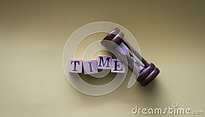 TIME word written on wood block put beside sandclock,vintage and art tone Stock Photo