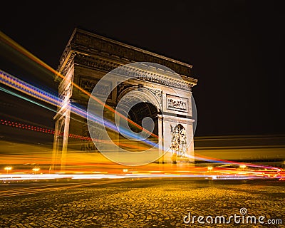 Timelapse shot of light trails around Arc de Triomphe in Paris, France Stock Photo