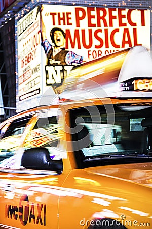 Times Square, New York City, New York, United States - circa 2012 - taxi cab driving in motion blurry times square at night Editorial Stock Photo