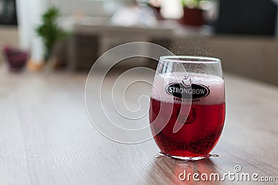 Strongbow glass on a wooden table Editorial Stock Photo