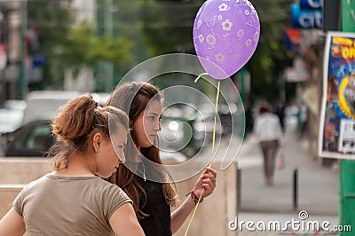 Girl holding a balloon Editorial Stock Photo