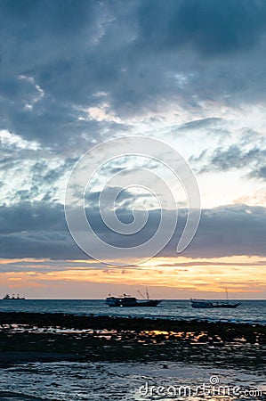 A sunset of beach with fisherman boats as background, Dili Timor Leste Editorial Stock Photo