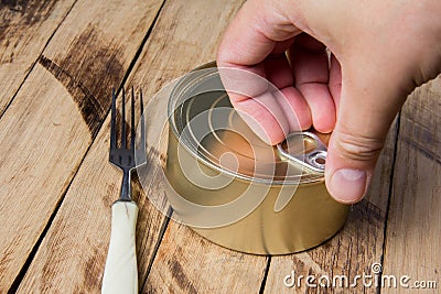 Tin can for food on wooden background. Packaging, product. Storage of food for a long time Stock Photo