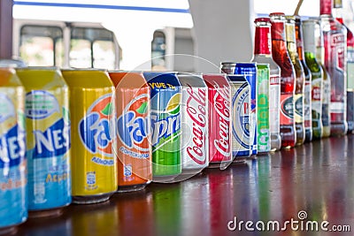 Tin cans and bottles of soft and alcoholic drinks standing in a row Editorial Stock Photo