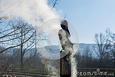 Winter Rooftop: Tin Chimney Emitting Smoke on a Sunny Day Stock Photo