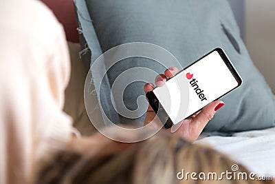 Tinder app on the screen of cell phone. Editorial Stock Photo