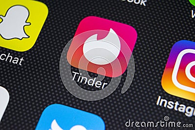 Tinder application icon on Apple iPhone X screen close-up. Tinder app icon. Tinder application. Social media icon. Social network. Editorial Stock Photo