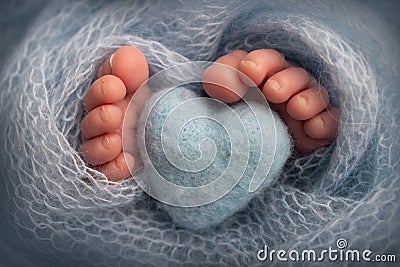 The tiny foot of a newborn baby. Soft feet of a new born in a light blue blanket Stock Photo