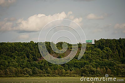 Tiny green house on the hill Stock Photo