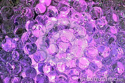 Tiny hard plastic beads balls in purple color background Stock Photo