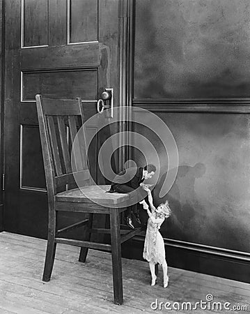 Tiny man and woman trying to unlock door Stock Photo