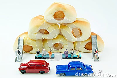 Tiny toys businessman and Sausage bread.Concept food background. Stock Photo