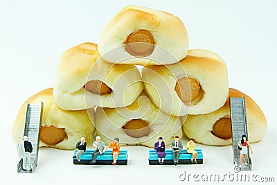 Tiny toys businessman and Sausage bread.Concept food background. Stock Photo
