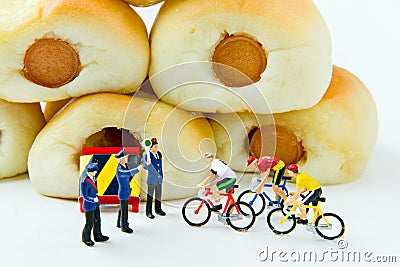 Tiny toys businessman and Sausage bread.Concept food background. Stock Photo