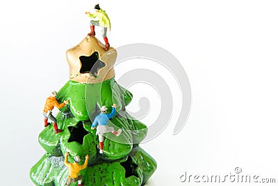 Tiny toys climbing on the Christmas tree. Stock Photo