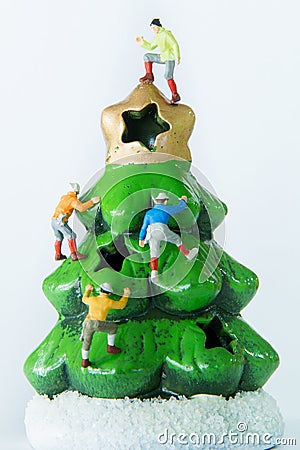 Tiny toys climbing on the Christmas tree. Stock Photo