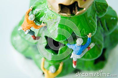 Tiny toys climbing on the Christmas tree. Stock Photo