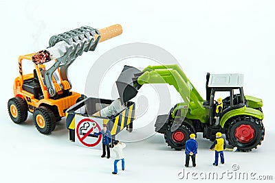 Tiny toys destroy cigarette.Concept No Smoking Day. Stock Photo