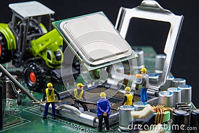 Tiny toys team of engineers repairing circuit mother board computer.Computer equipment.Computer repair concept Stock Photo