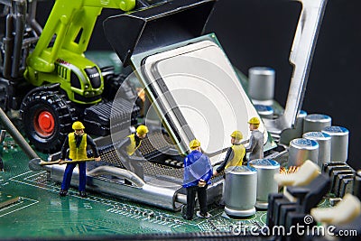 Tiny toys team of engineers repairing circuit mother board computer.Computer equipment.Computer repair concept Stock Photo