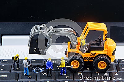 Tiny toys team of engineers repairing keyboard computer laptop.Computer equipment.Computer repair concept Stock Photo