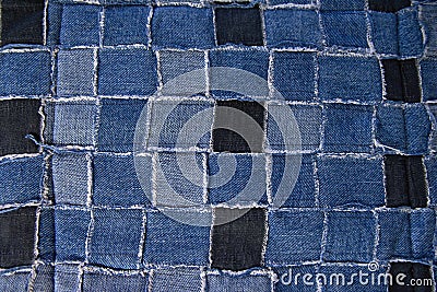 Tiny vintage fabric pieces sewn together into a patchwork for a quilt top. blue background texture Stock Photo