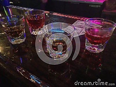 Tip money on bar with shots of liquor Stock Photo