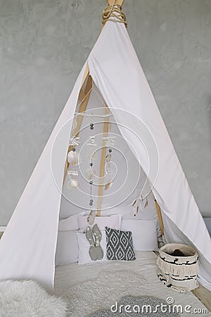 Nursery in Scandinavian style. Scandi child room interior in real photo. Decorative boho styled hut, tipi, wigwam Stock Photo