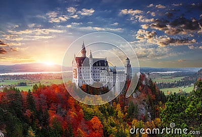 Tipical postcard. Majestic Neuschwanstein castle during sunset, with colorful clouds under sunlight. Dramatik Picturesque scene. Stock Photo