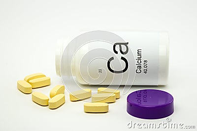 Tipped over bottle of Calcium vitamins Stock Photo