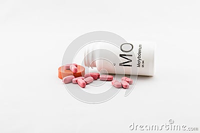 Tipped over bottle of molybdenum vitamins Stock Photo