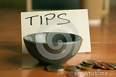 Tipping bowl in coffee shop with coins Stock Photo