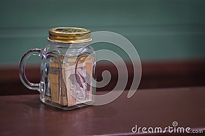 Tipping in a glass jar on a bar counter top Stock Photo