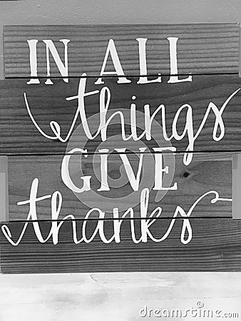 Tips in all things give thanks print on wood wall Stock Photo