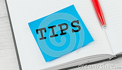 Tips word on a notebook with red pen Stock Photo