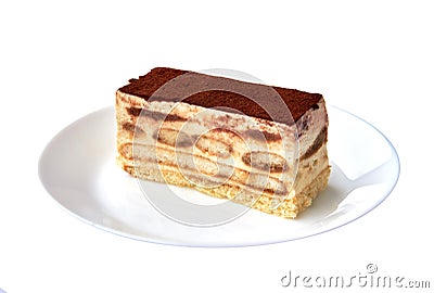 Tiramisu cake/ traditional italian dessert with cacao on a porcelain plate on the white background. Close up. Stock Photo
