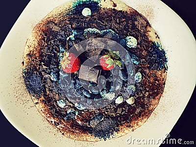 Tiramisu dessert with chocolate, strawberries and honeysuckle berries Stock Photo