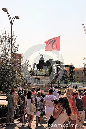 Tirana, Albania, August 2013. A group of tourists in front of the monument to the national hero. Editorial Stock Photo