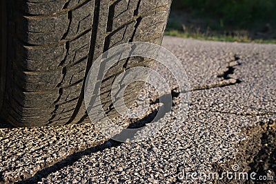 Tire And Cracked Asphalt Stock Photo