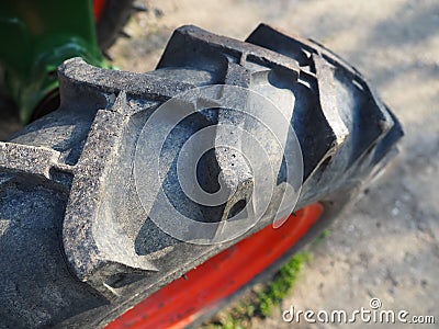 tire from a motor-cultivator. A close-up of a wheel from a small farm tractor. Rubber thread. Industrial details. Stock Photo