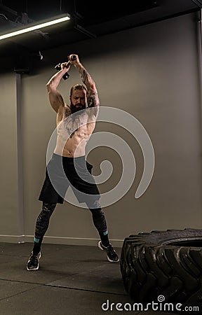 Tire muscular hammer beard wheel tattoo sledge man fitness body, concept athlete training from heavy from club caucasian Stock Photo