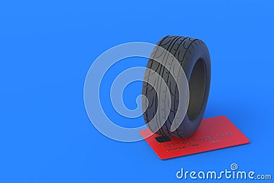 Tire near a credit card. The cost of replacing car wheels Stock Photo