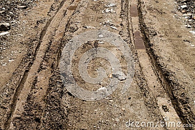 Tire tracks on muddy dirt road Stock Photo