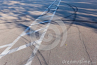 Tire tracks and road marking on the asphalt surface Stock Photo