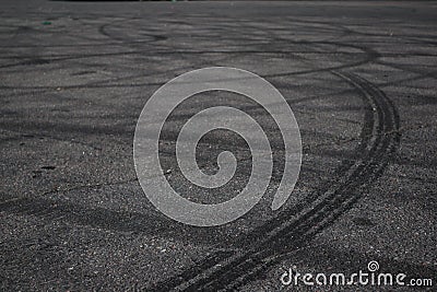 Tire tracks. wheel track on asphalt road. asphalt with traces of car wheels. Traces of braking from rubber tyres on cement. Abstra Stock Photo