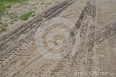 Tire or tractor marks in brown dirt or sand Stock Photo