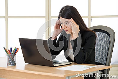 Tired asia businesswoman with headache in the office Stock Photo